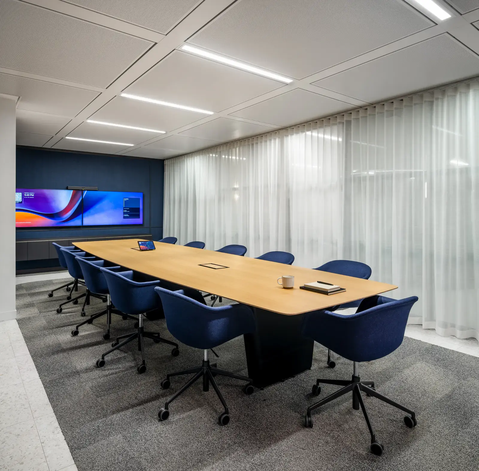 Waypoint Insurance boardroom with blue seating and a glazed wall