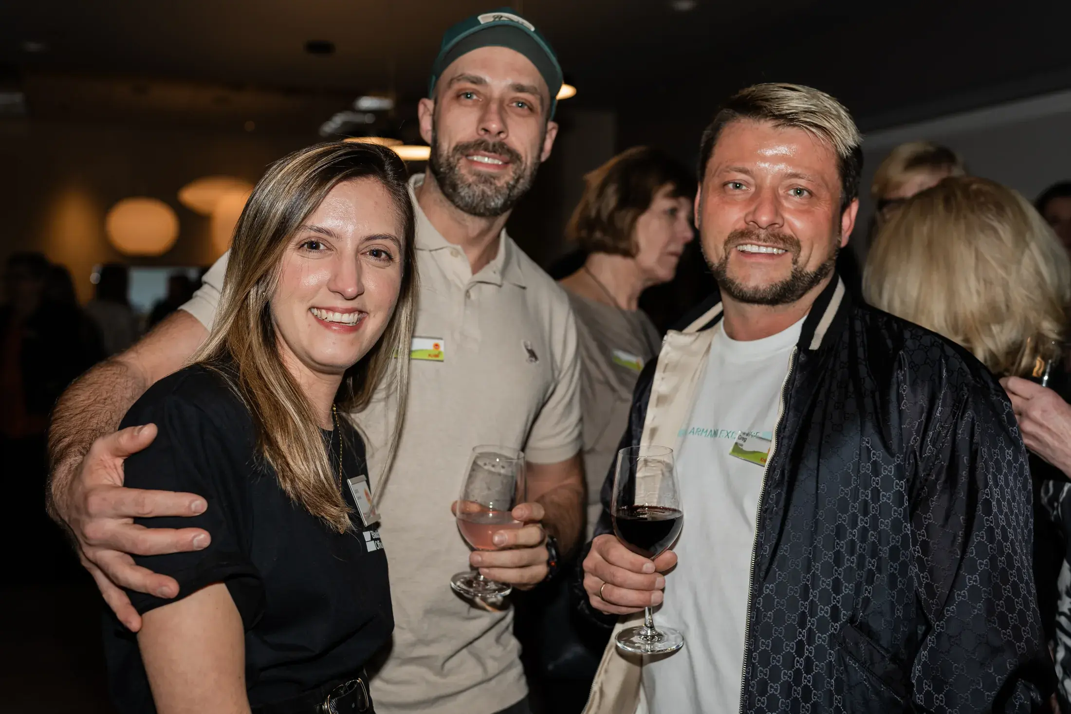 Three guests smiling together at the Blackburn Young Spring Party
