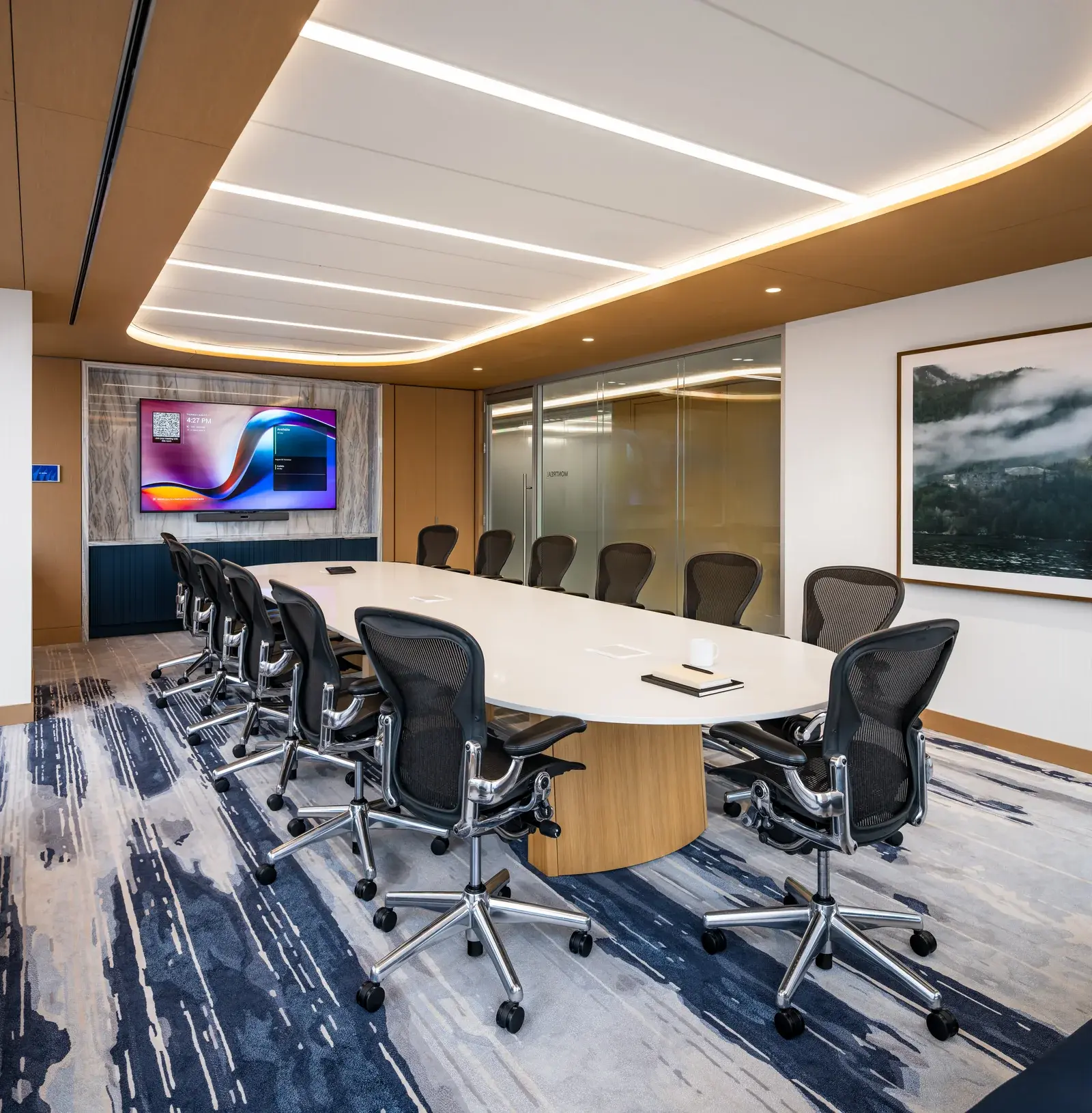 Meeting room with conference table and upholstered chairs