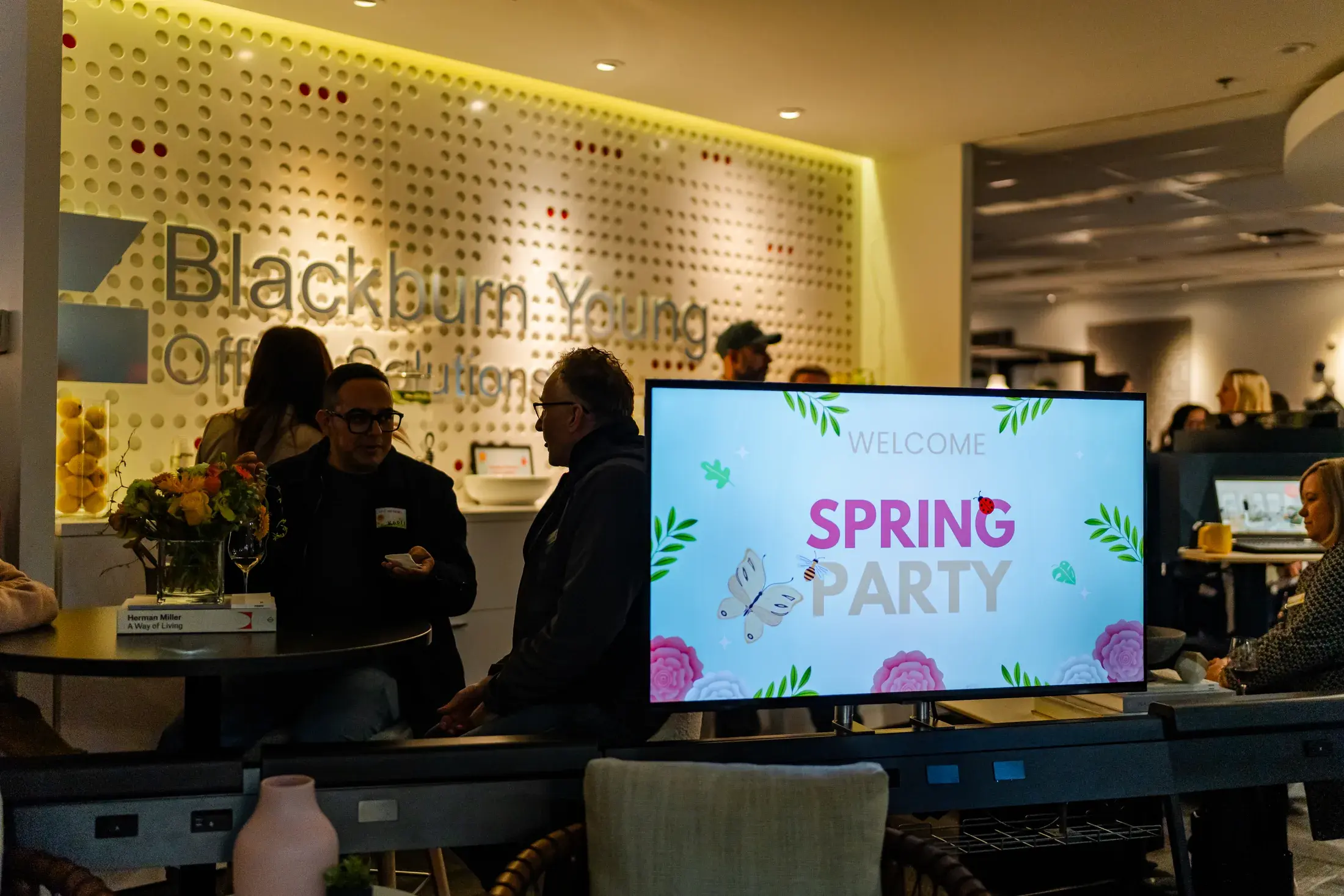 Blackburn Young showroom with the Spring Party invitation displayed among workplace settings