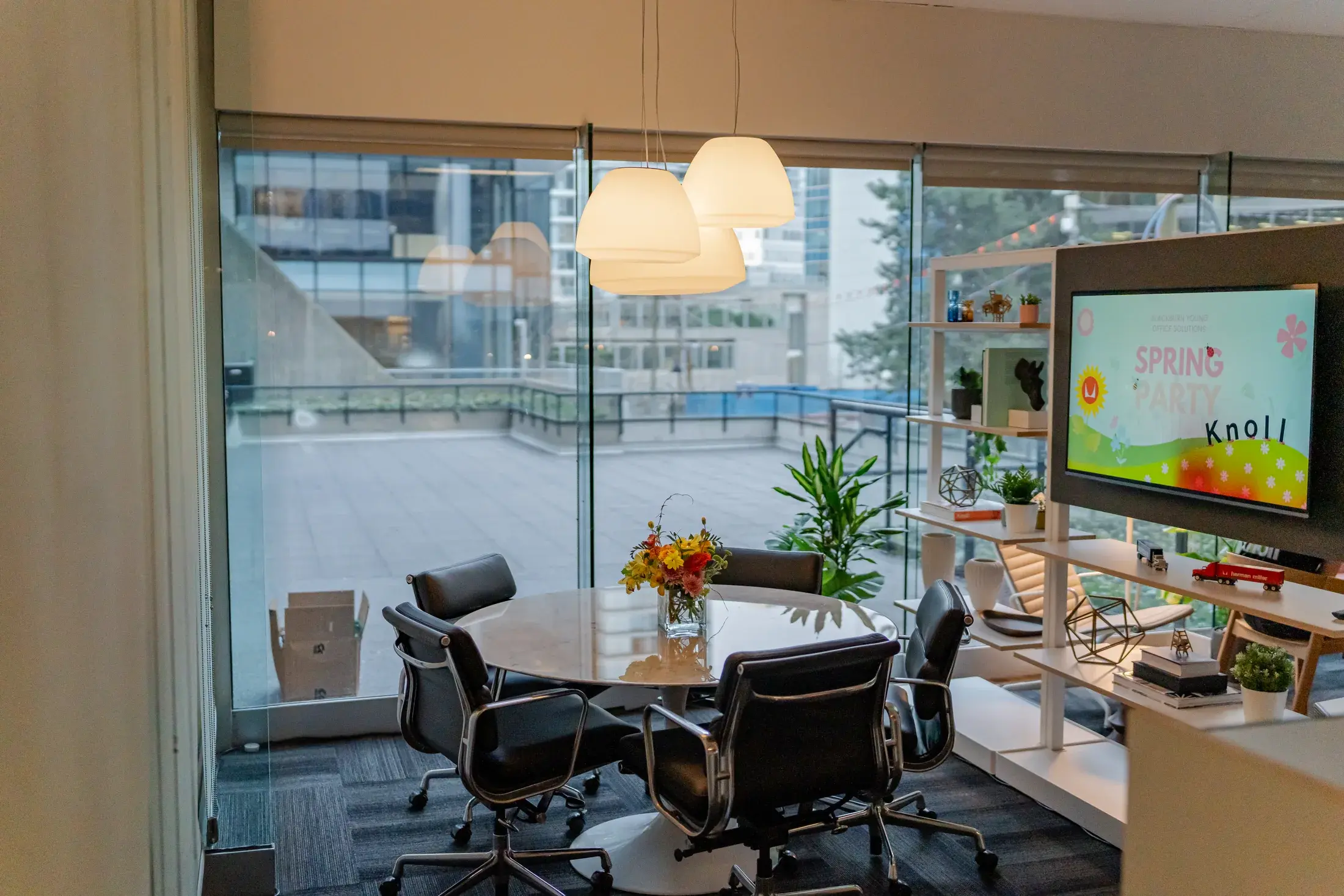 Meeting setting in the refreshed showroom with the Spring Party invitation on a screen