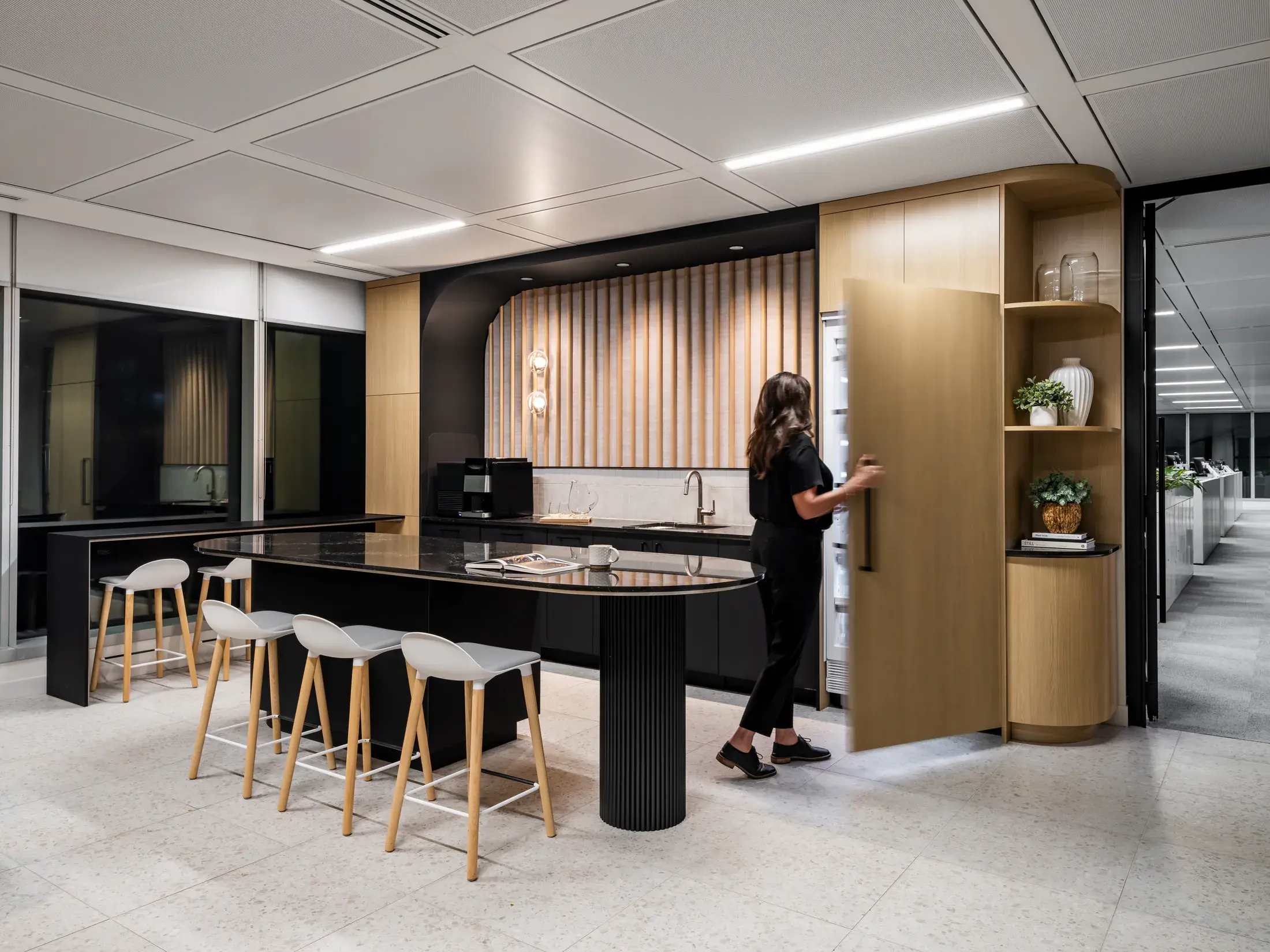 Waypoint Insurance social hub with an island, stools and integrated cabinetry