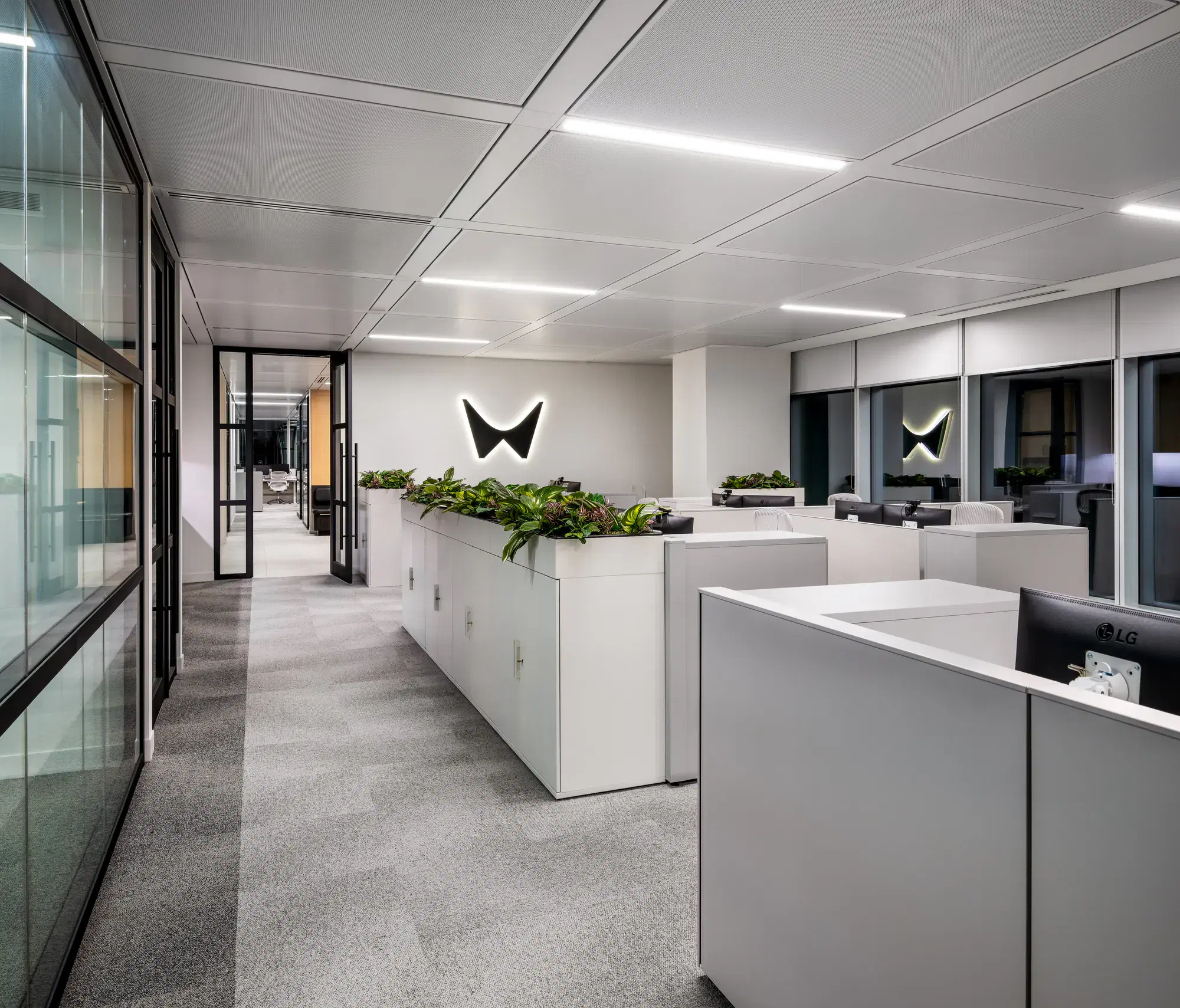 Waypoint Insurance workstation area with glazed perimeter rooms