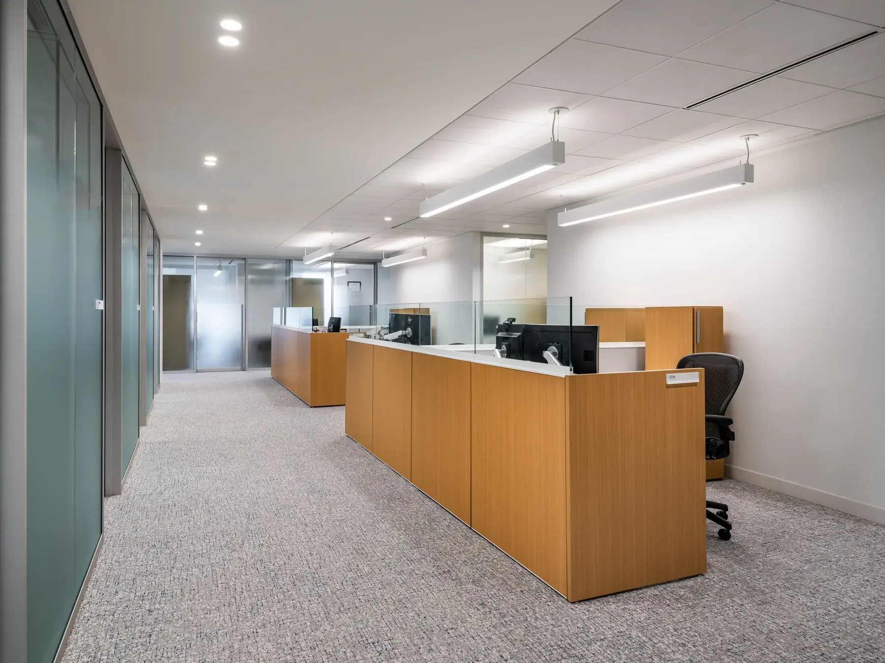 Workstations beside glazed rooms in the Stikeman Elliott workplace