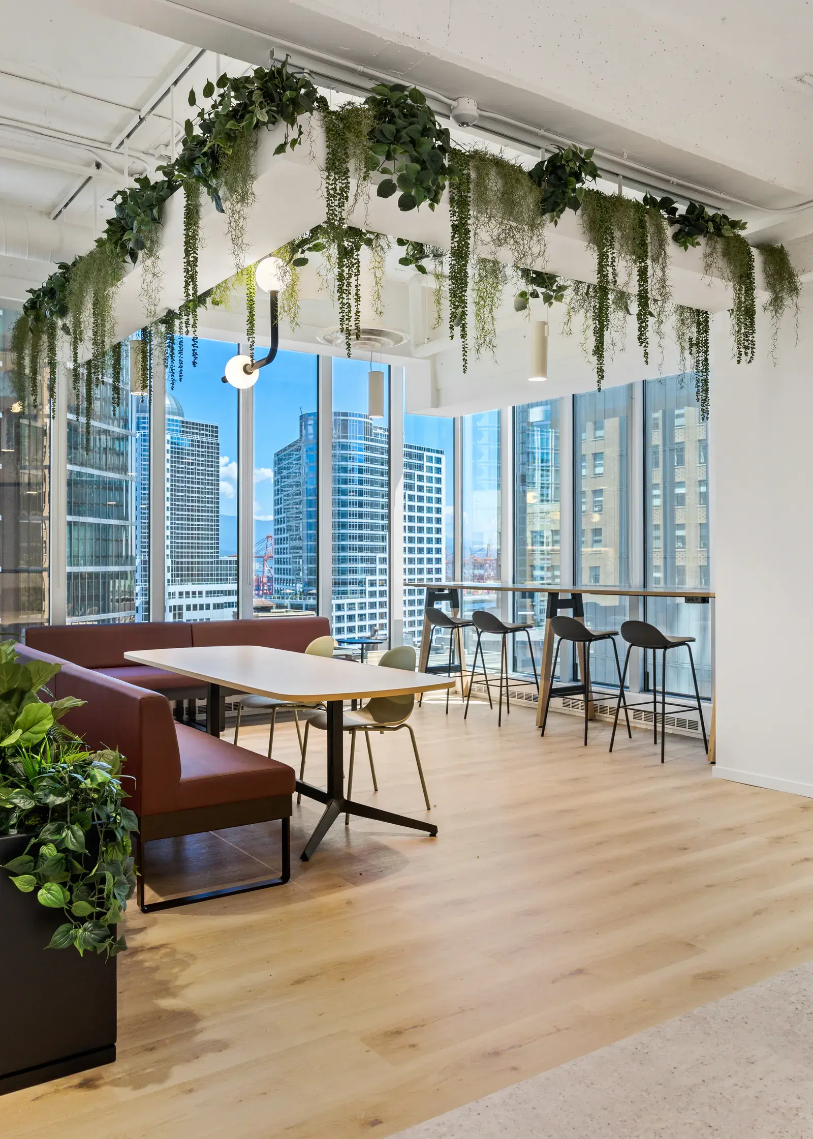 Plant-filled collaboration setting overlooking downtown Vancouver
