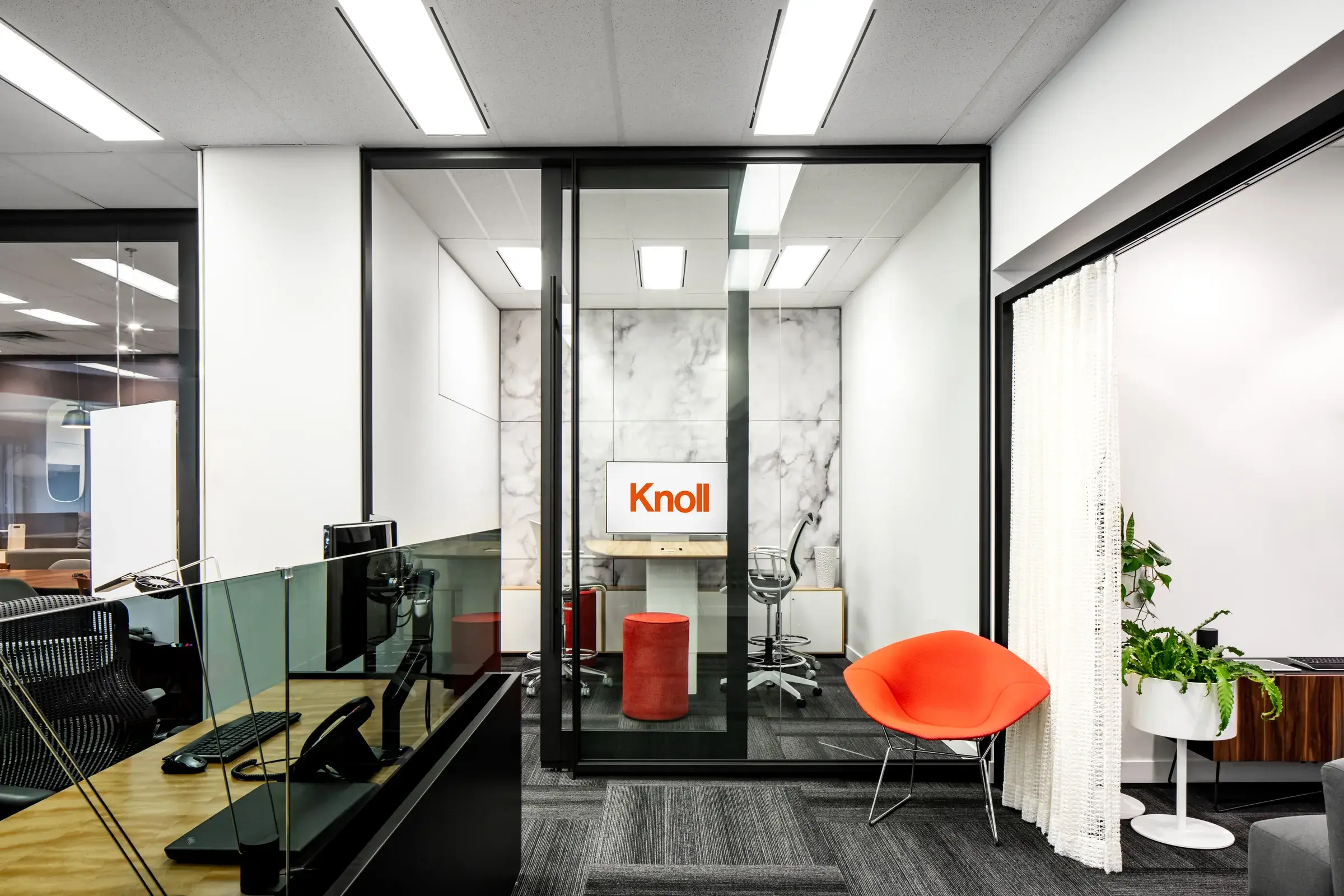 A layered view connecting workstations, an enclosed room and lounge seating