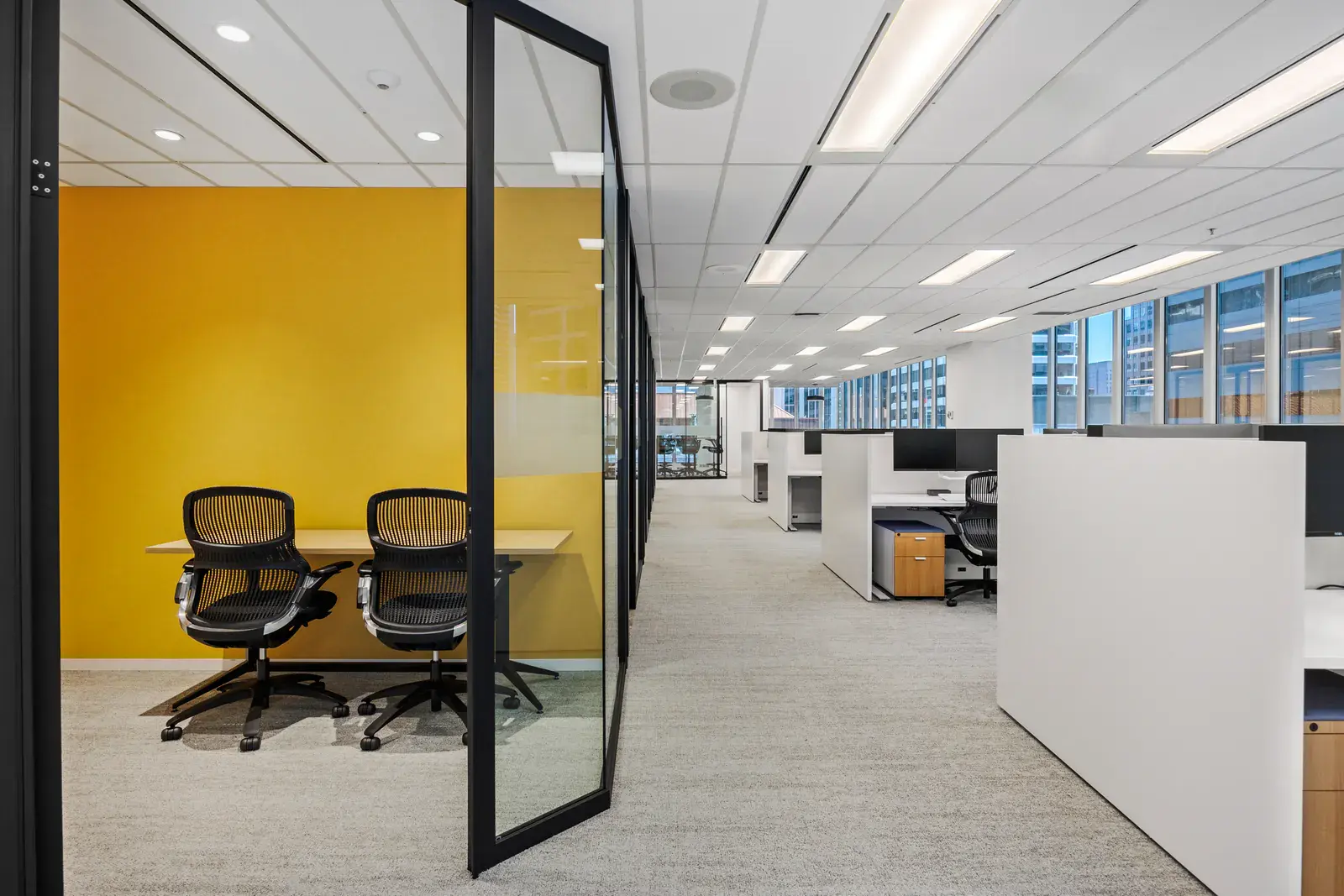 Glazed collaboration room connecting to the open workplace