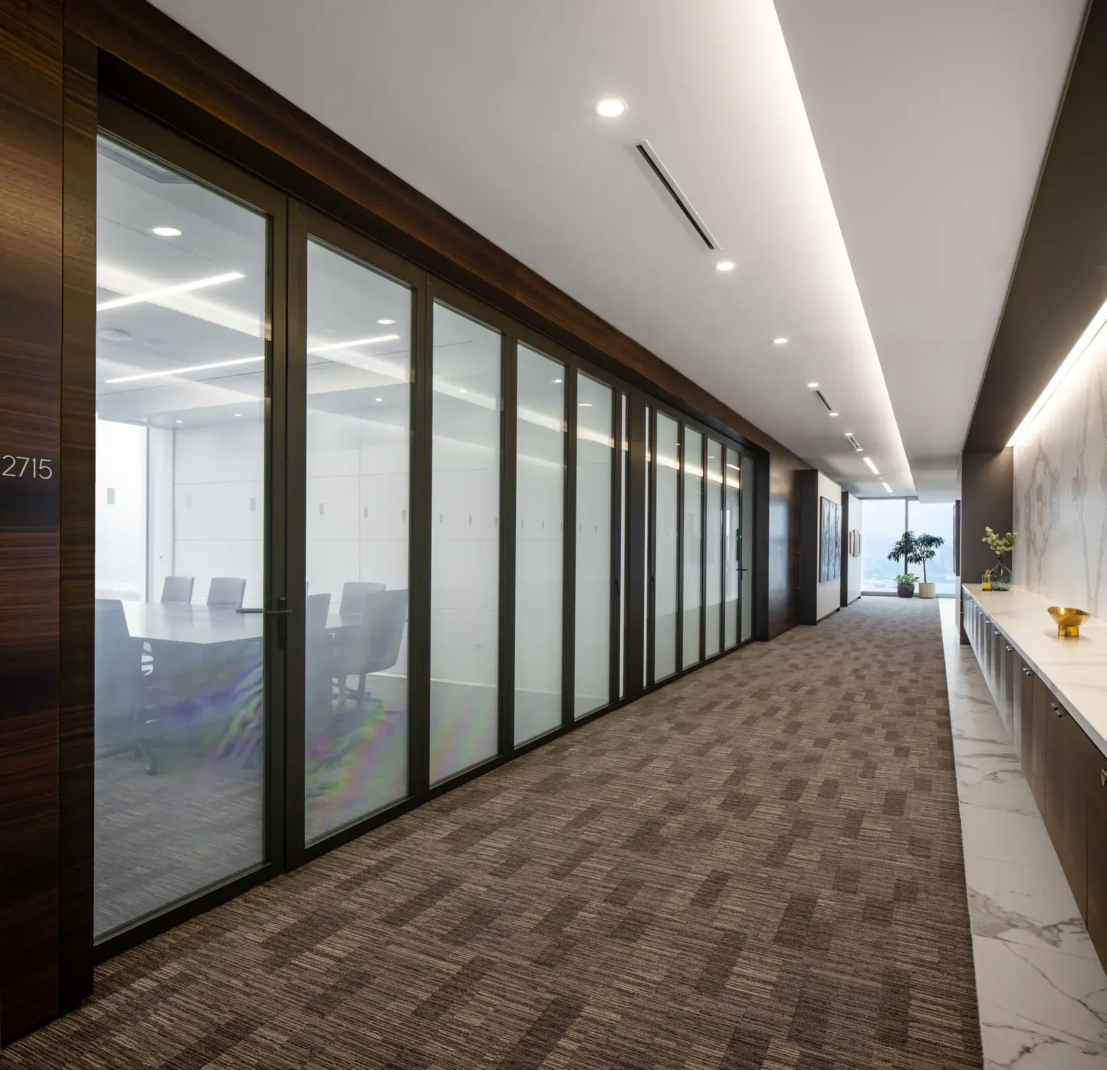 Glazed meeting-room partition along a DLA Piper corridor