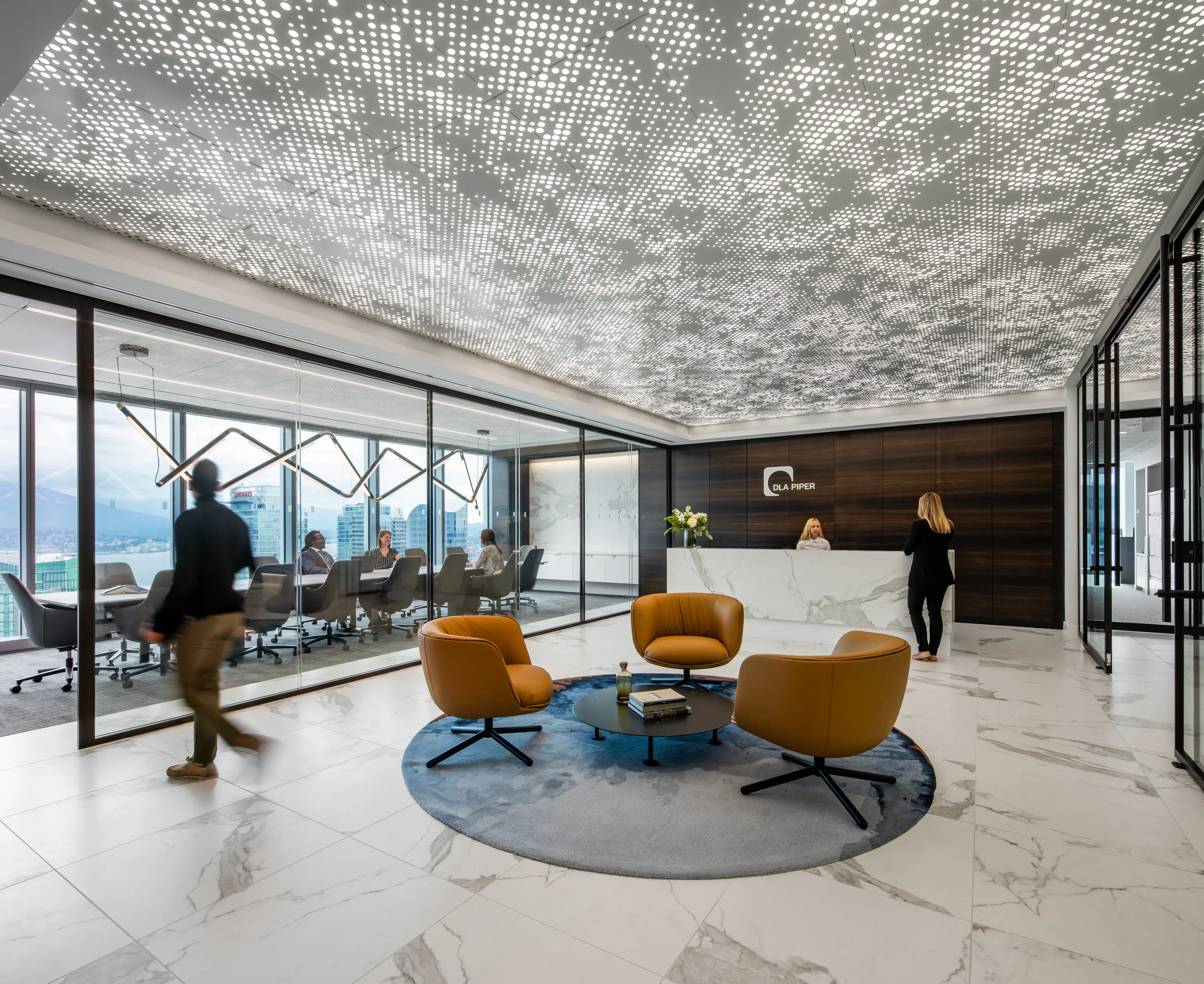 DLA Piper Vancouver reception with lounge seating and an illuminated feature ceiling