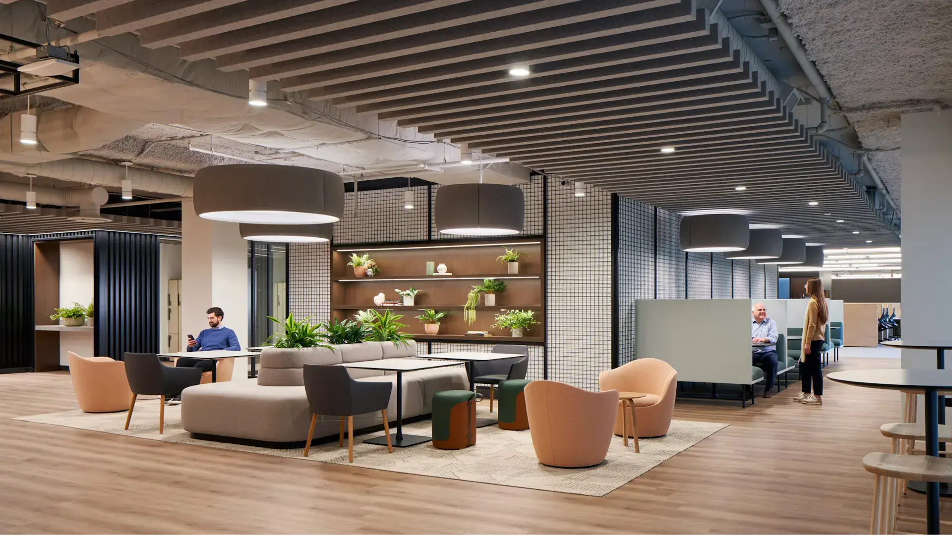 Contemporary workplace with collaborative seating, architectural elements and people