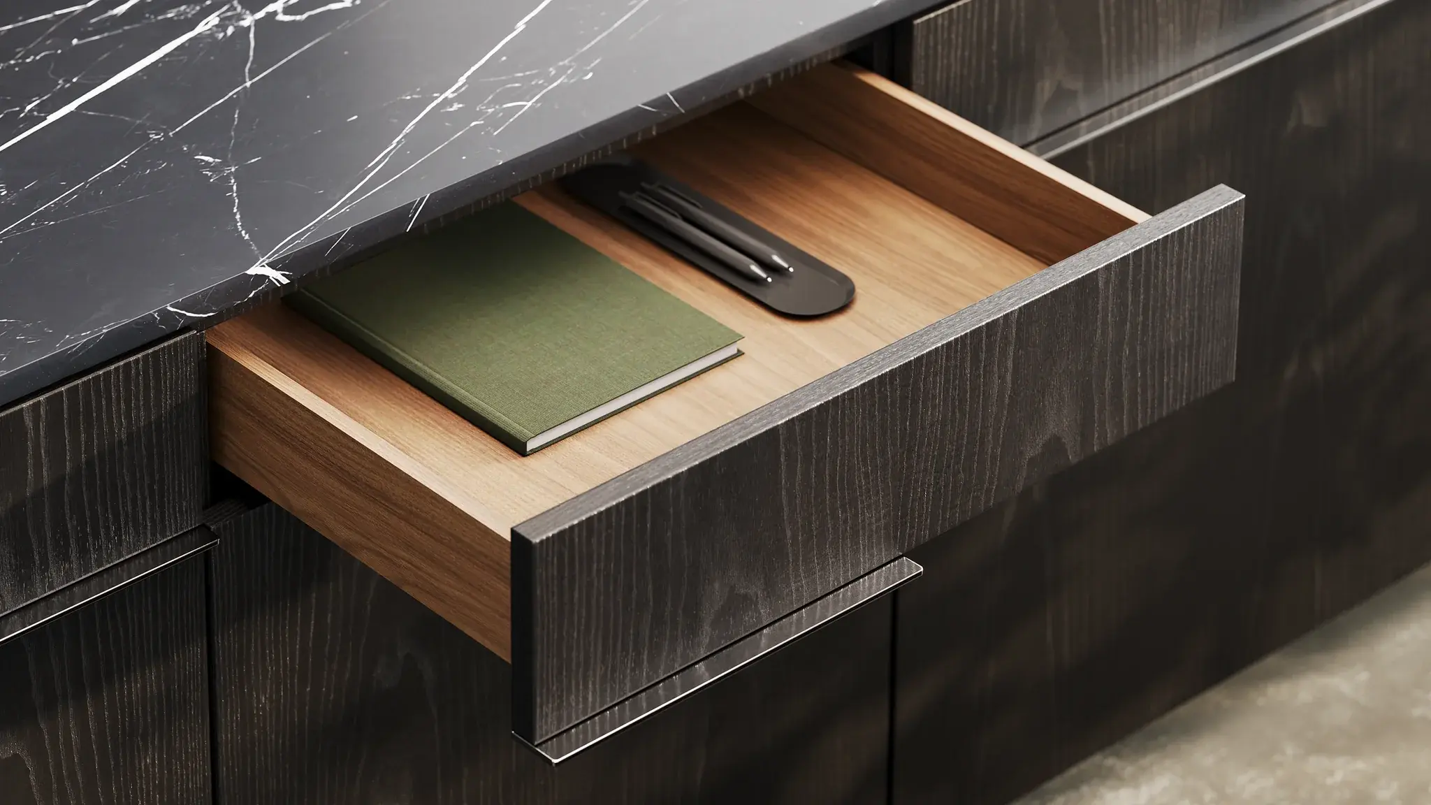 Close view of crafted furniture details and an open drawer