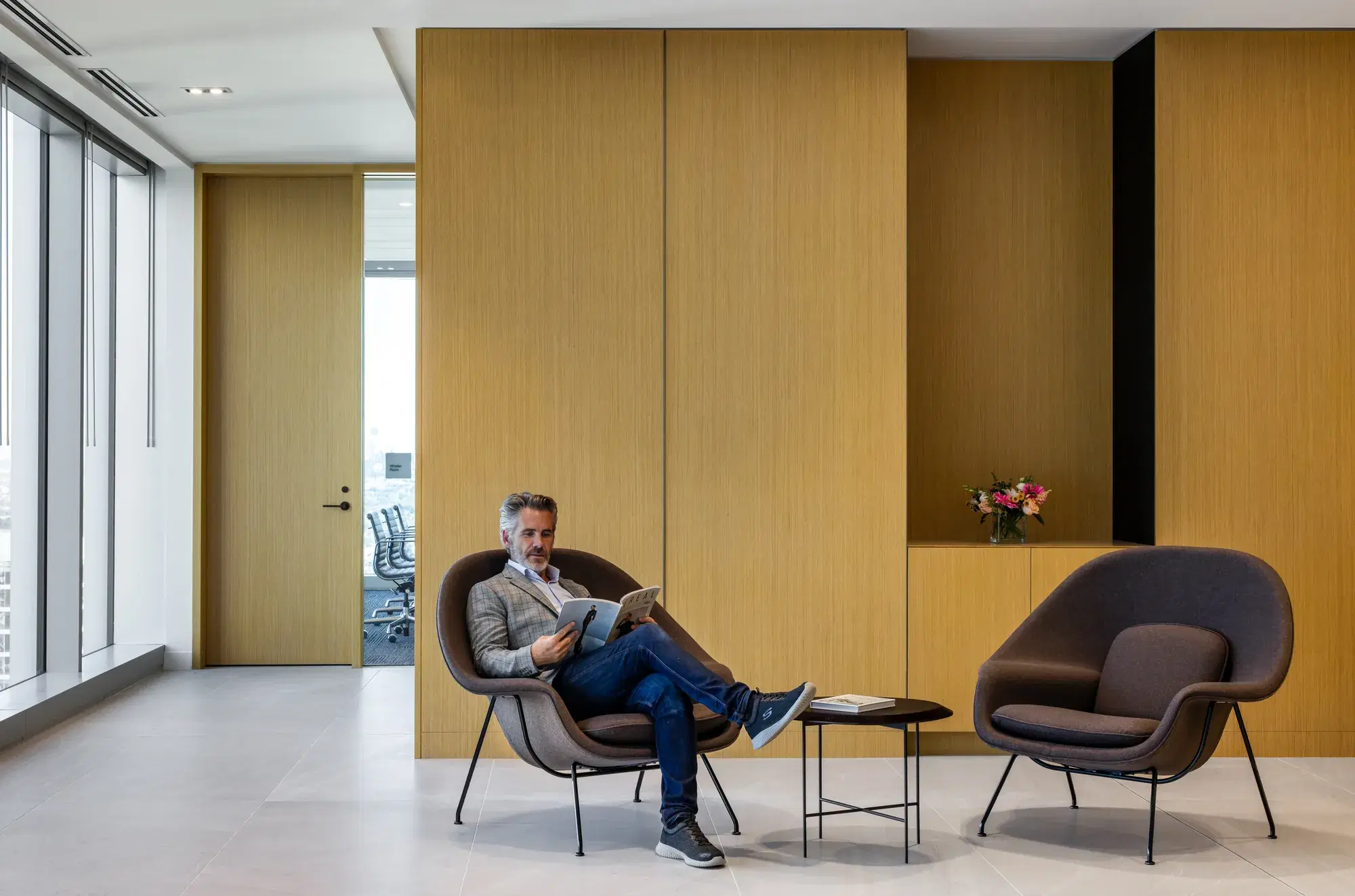 Lounge seating against warm wood paneling