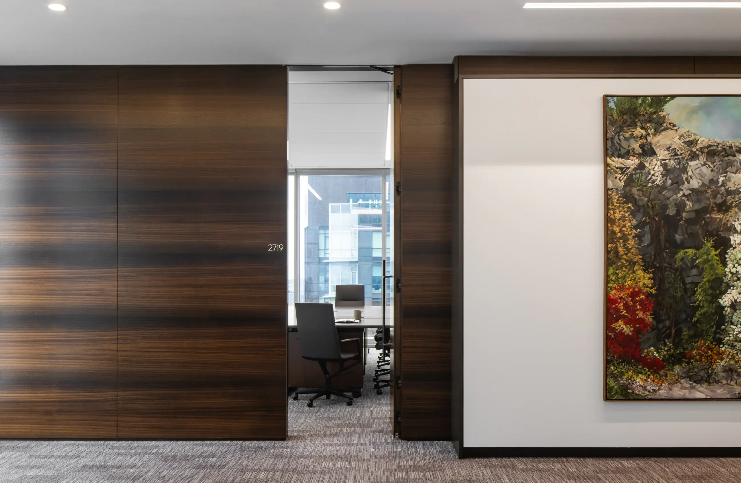 Private office entrance beside a large artwork