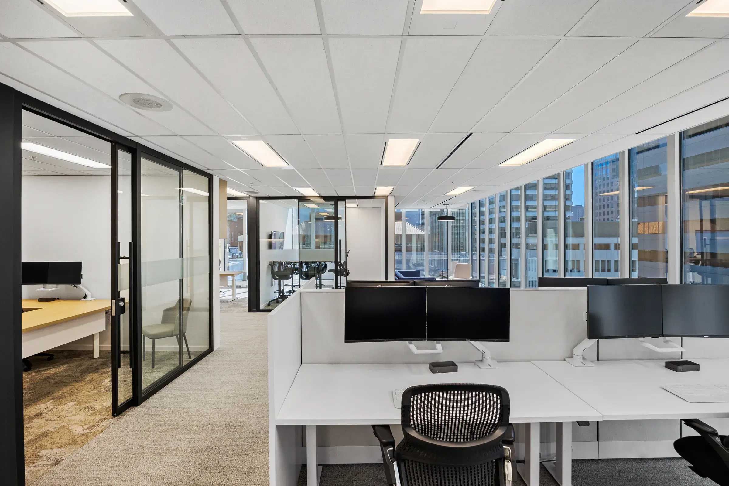 Workplace with furniture workstations and glass architectural interiors