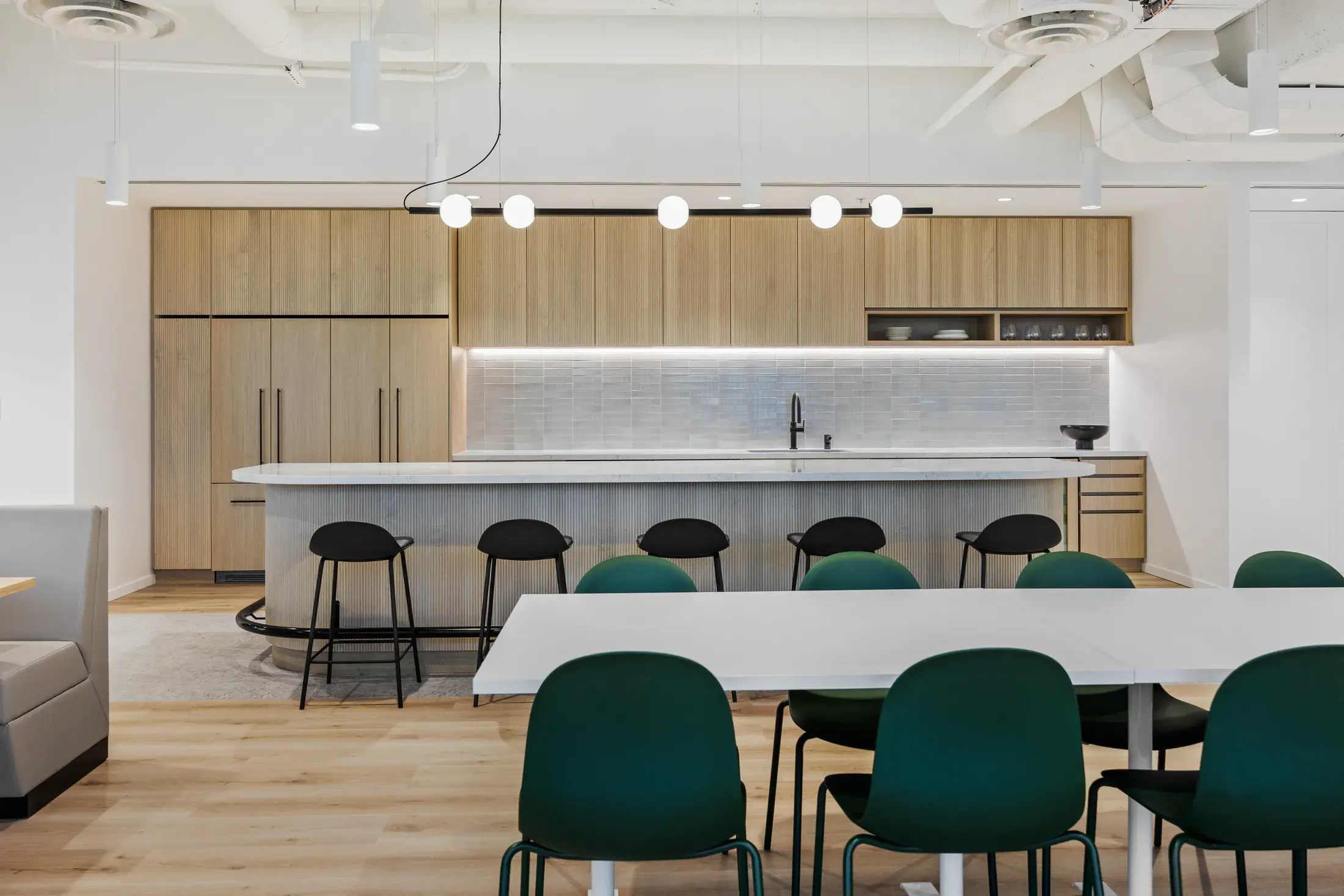 Baker Tilly social hub with communal tables, kitchen and varied seating