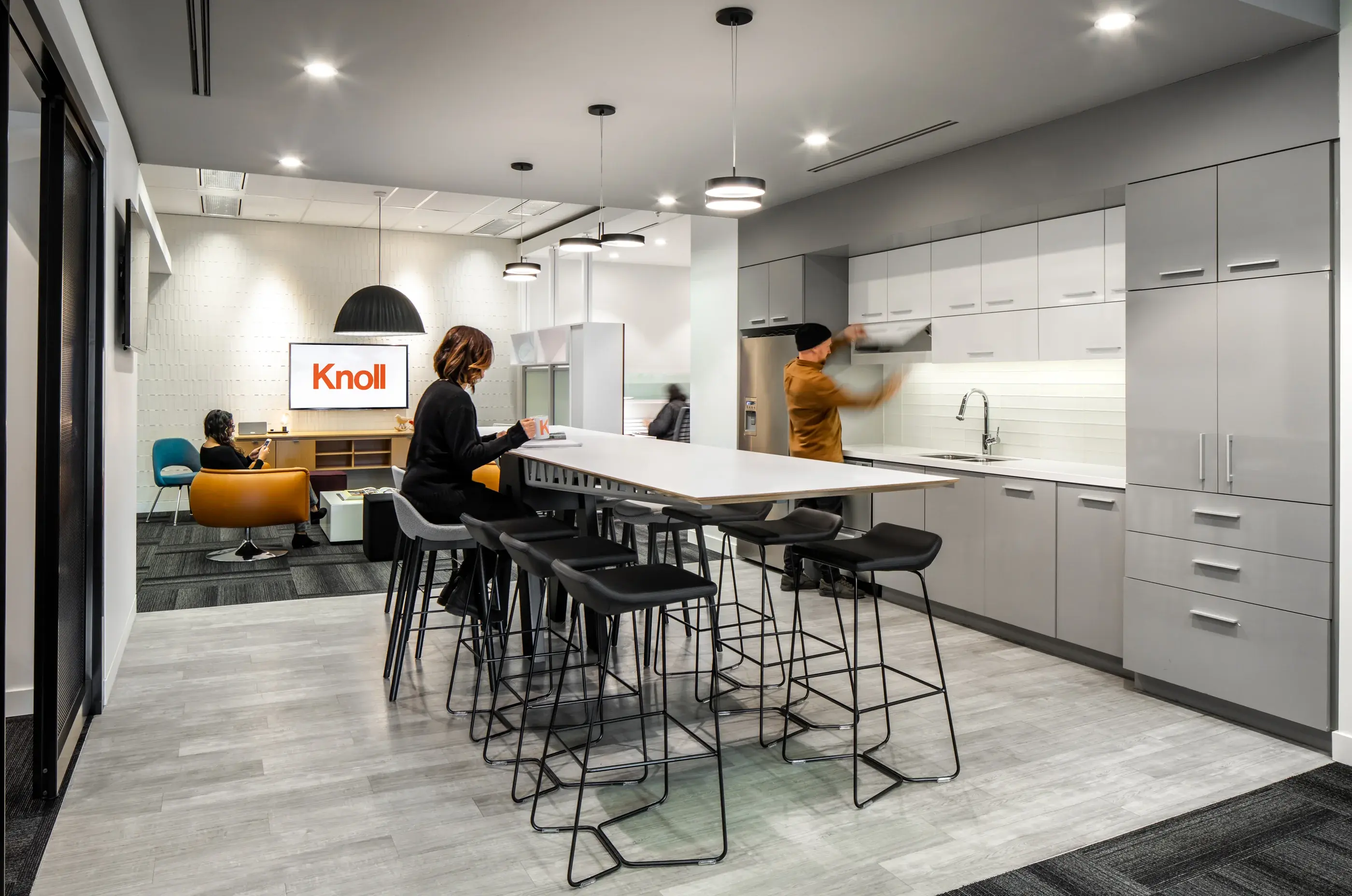People using the kitchen and social hub in Blackburn Young's workplace